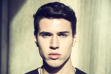 Handsome young man's headshot, indoor, lit by sunlight 