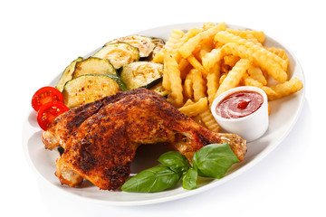 Grilled chicken legs with chips and vegetables 