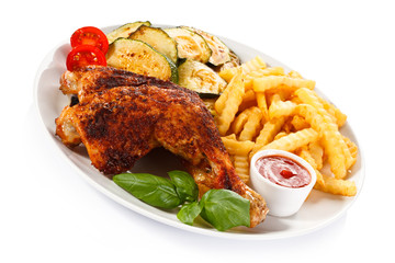 Grilled chicken legs with chips and vegetables 