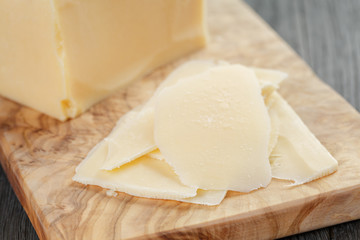 Fototapeta na wymiar parmesan cheese sliced on olive board
