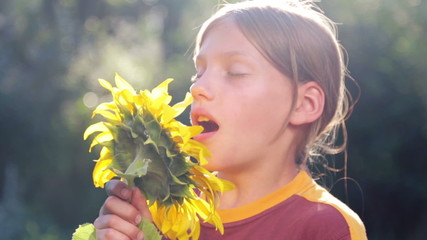 Portrait of a boy with a flower sunflower. 