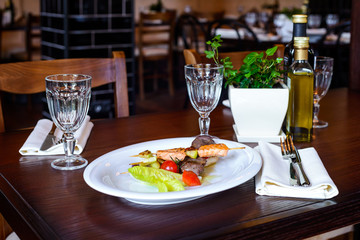 Skewers of salmon and tuna with cherry tomatoes and salad leaf/Skewers of grilled salmon and tuna  on plate with cherry tomatoes and salad leaf
