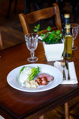 Grilled beef steak/Sliced steak and cheese with vegetables and sauce on a white plate