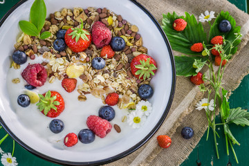 Fresh granola with yogurt and berry fruits