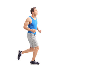 Young man in sportswear running and smiling