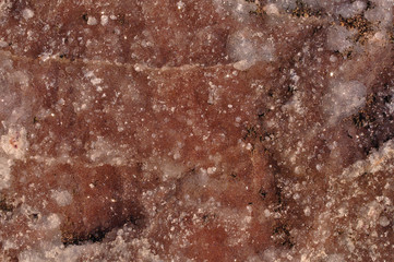 A rock wall covered by small crystals of amethyst 