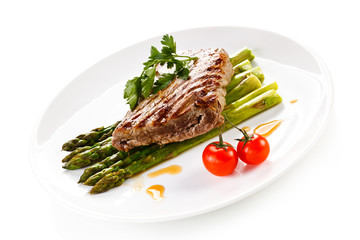 Grilled beefsteak and asparagus on white background