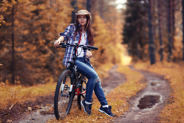 Obraz na płótnie Canvas teen girl bike Forest Indian Summer