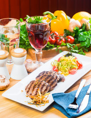 Grilled steaks with fresh vegetables