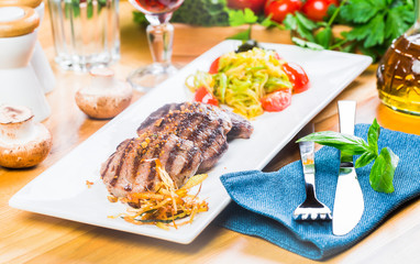 Grilled steaks with fresh vegetables