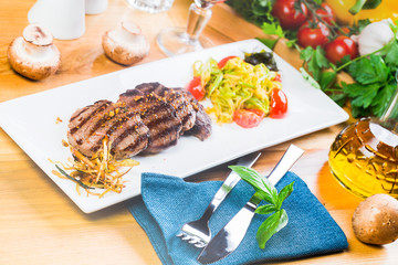 Grilled steaks with fresh vegetables