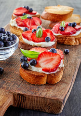 toasted bread with berries and cream cheese