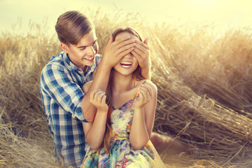 Happy couple having fun outdoors on wheat field, love concept