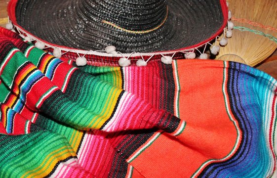 Mexican poncho sombrero poncho background Mexico with sombrero cinco de mayo background mexico fiesta copy space pattern stripes copy space serape stock photo photograph picture image