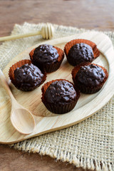 Chocolate balls on wooden plate and spoon