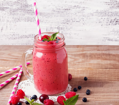 Summer berries smoothie in a glass mug