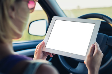 Woman using tablet pc in the car
