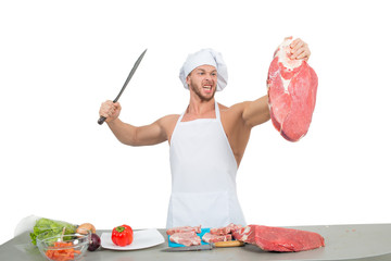 chef bodybuilder preparing large chunks of raw meat.