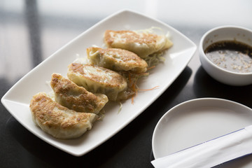 Jiaozi , Chinese dumpling on black table with  sauce