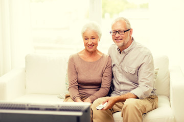Fototapeta na wymiar happy senior couple watching tv at home