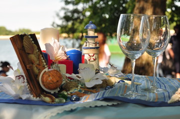 Glasses are on the festive table in the style of the wedding in the marine theme.