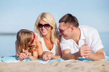 Fototapeta na wymiar happy family on the beach