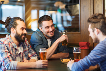 happy male friends drinking beer at bar or pub