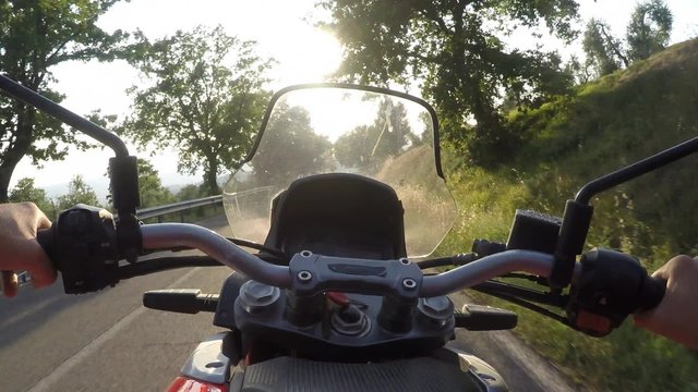 Man driving motorbike on sunset. POV, Original point of View 