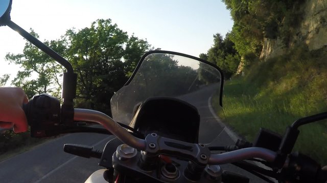 Man driving motorbike on sunset. POV, Original point of View 