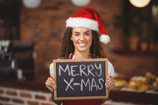 Pretty waitress with a chalkboard merry x-mas
