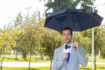 Successful handsome male journalist wearing light grey suit