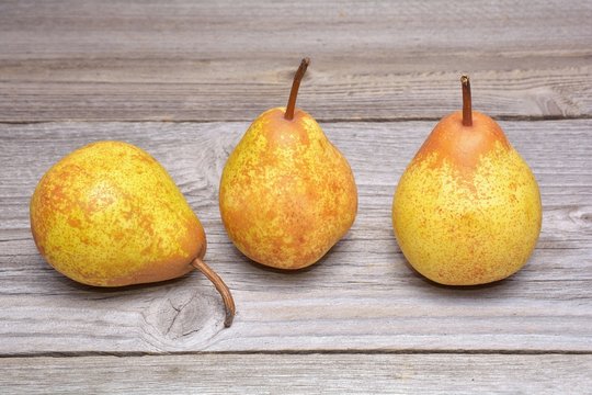 ripe pears on wooden background
