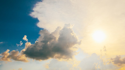 blue sky background with sun and white clouds