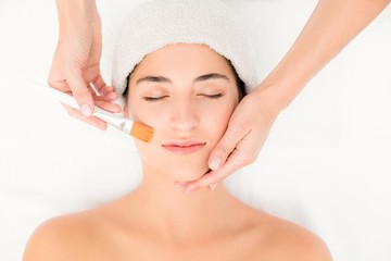 Attractive young woman receiving massage at spa center