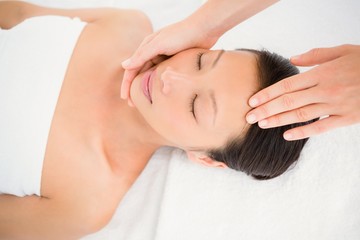 Fototapeta na wymiar Attractive young woman receiving head massage 