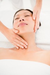 Attractive young woman receiving head massage 