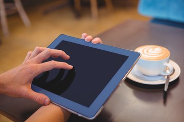  Close-up of digital tablet and coffee on table