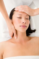 Attractive woman receiving facial massage