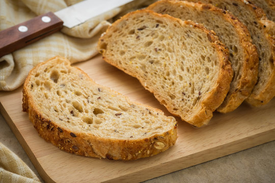 Whole grain bread on chopping board