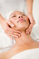 Attractive young woman receiving facial massage 