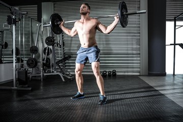 Fototapeta premium Muscular man lifting a barbell 