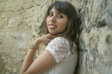 young  girl near a stone wall