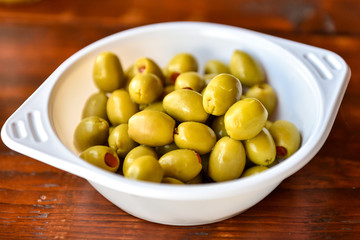 Plactic bowl of green olives