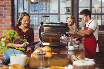 Handsome barista preparing a cup of coffee