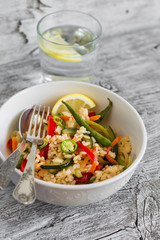 saute with rice and vegetables in a white bowl on a light background