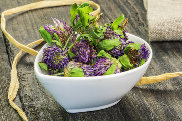 Dry red clover in white bowl