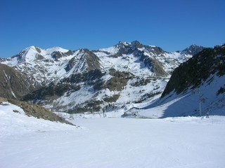 Fototapeta premium Snowy winter landscape in the mountains, in the French ski resort Isola 2000 in the Alps, on a sunny day.