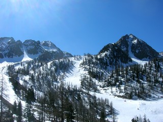 Snowy winter landscape in the mountains, in the French ski resort Isola 2000 in the Alps, on a sunny day.