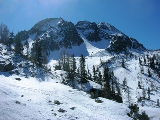 Snowy winter landscape in the mountains, in the French ski resort Isola 2000 in the Alps, on a sunny day.
