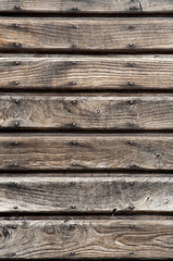 Fototapeta premium old wooden door with horizontal planks and nails